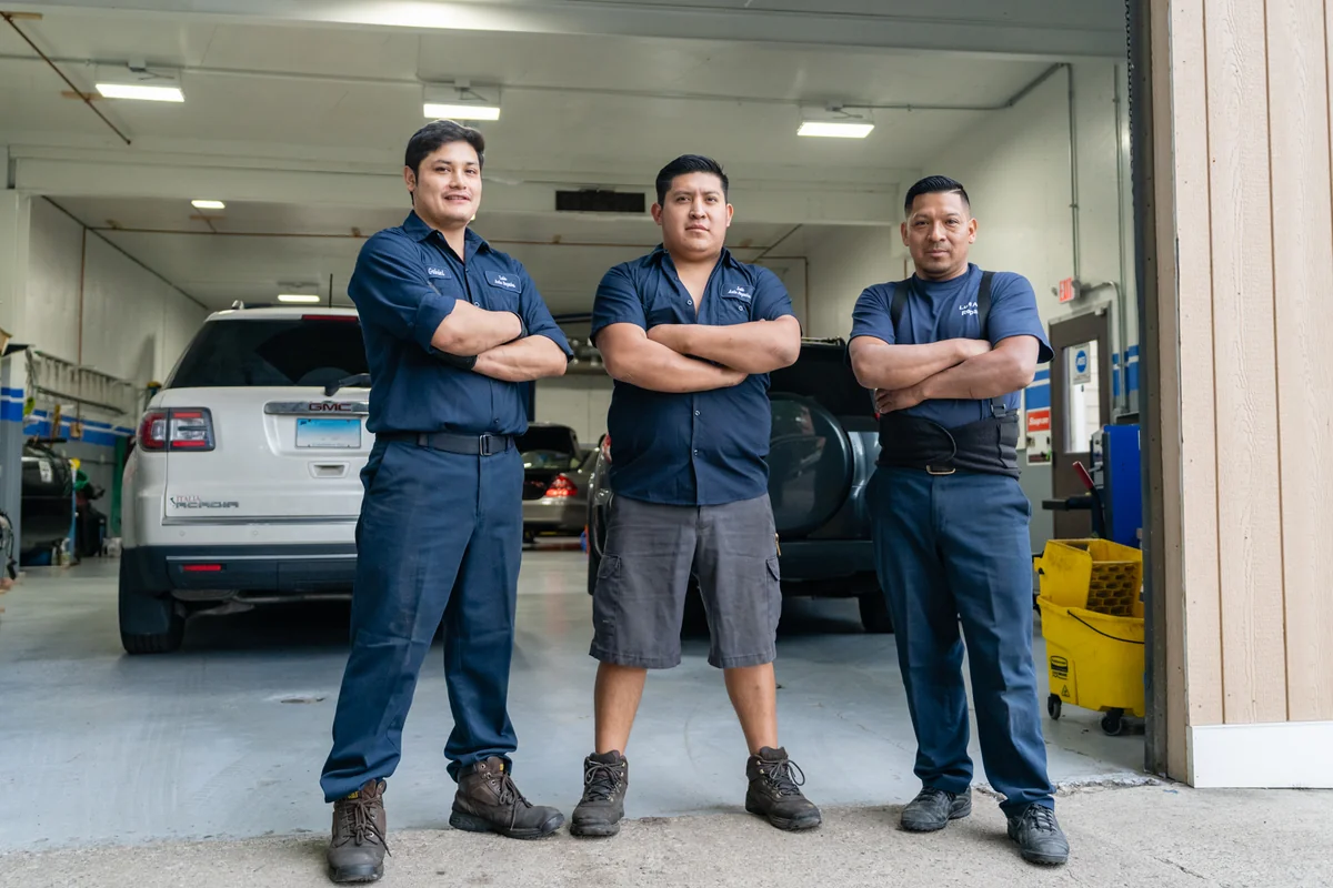 The Luis Auto Repairs team standing together inside the Danbury shop