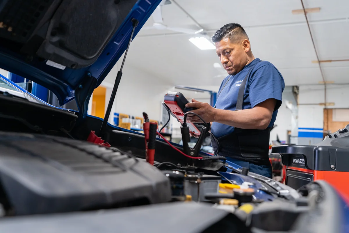Luis Auto Repairs technician testing a vehicle under the hood